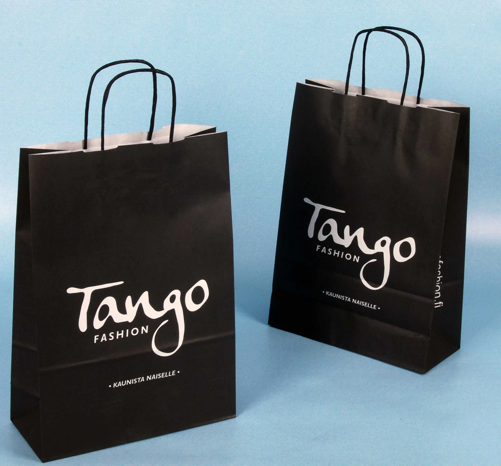 Two black paper bags with twisted handles and Tango Fashion printing